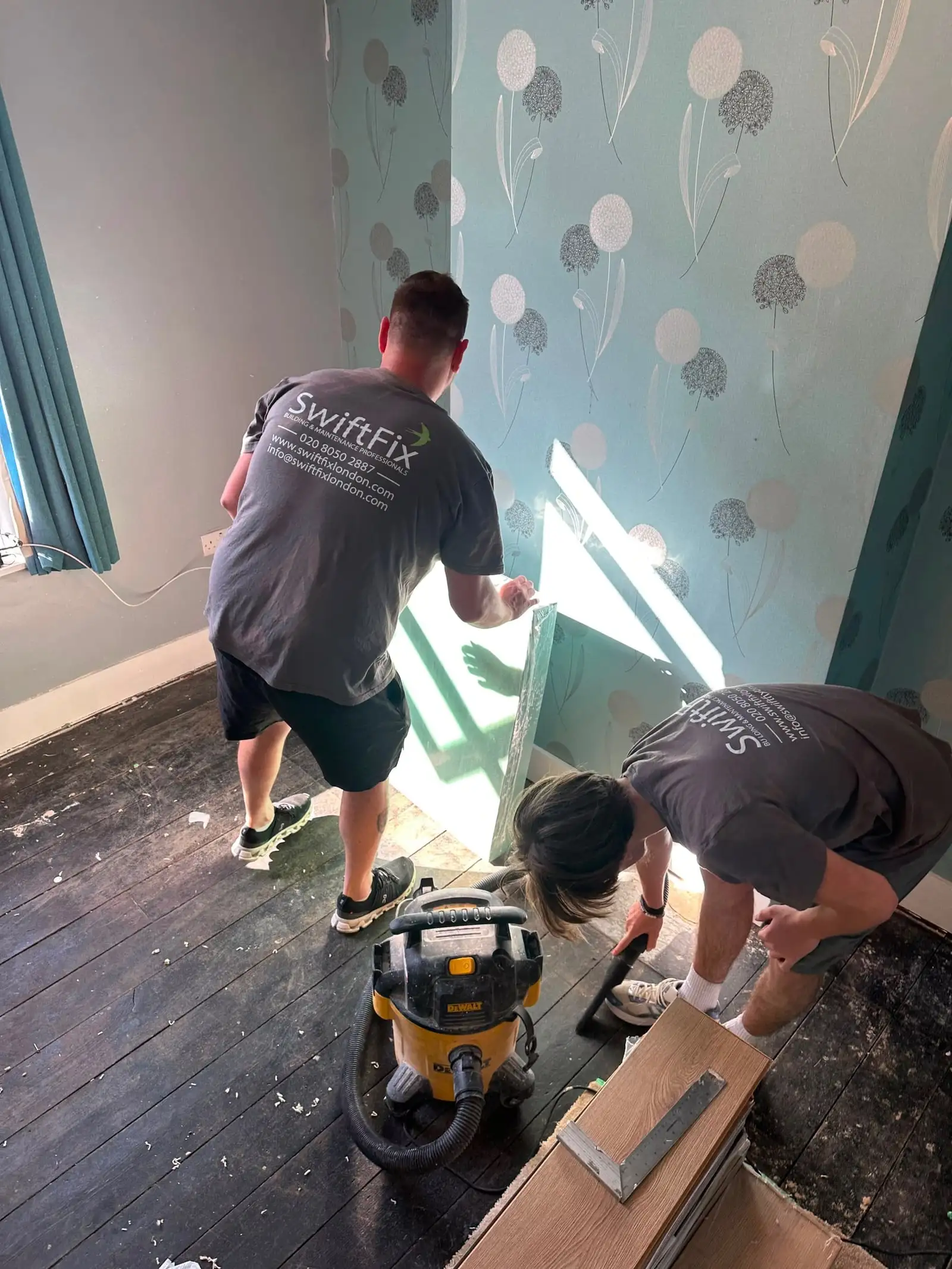 Swift Fix team stripping wallpaper and preparing a bedroom for refurbishment