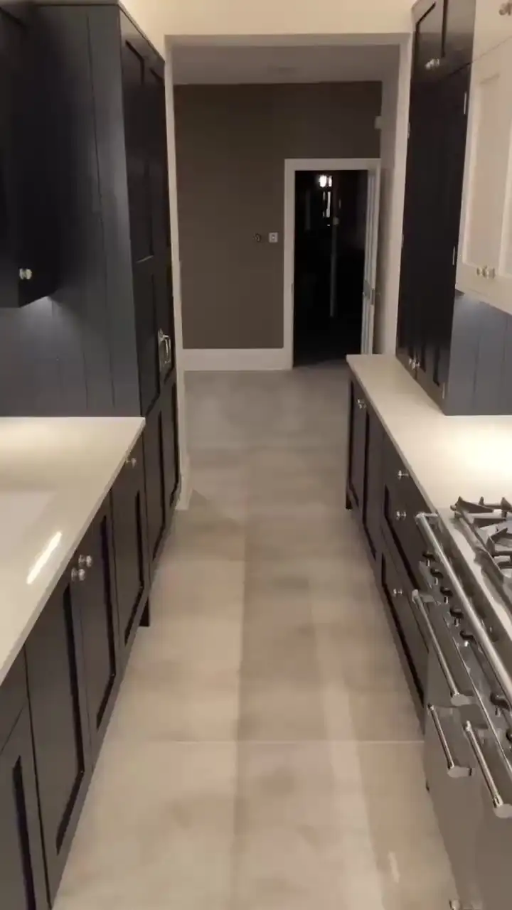 Dark shaker galley kitchen with pale large-format porcelain floor tiles