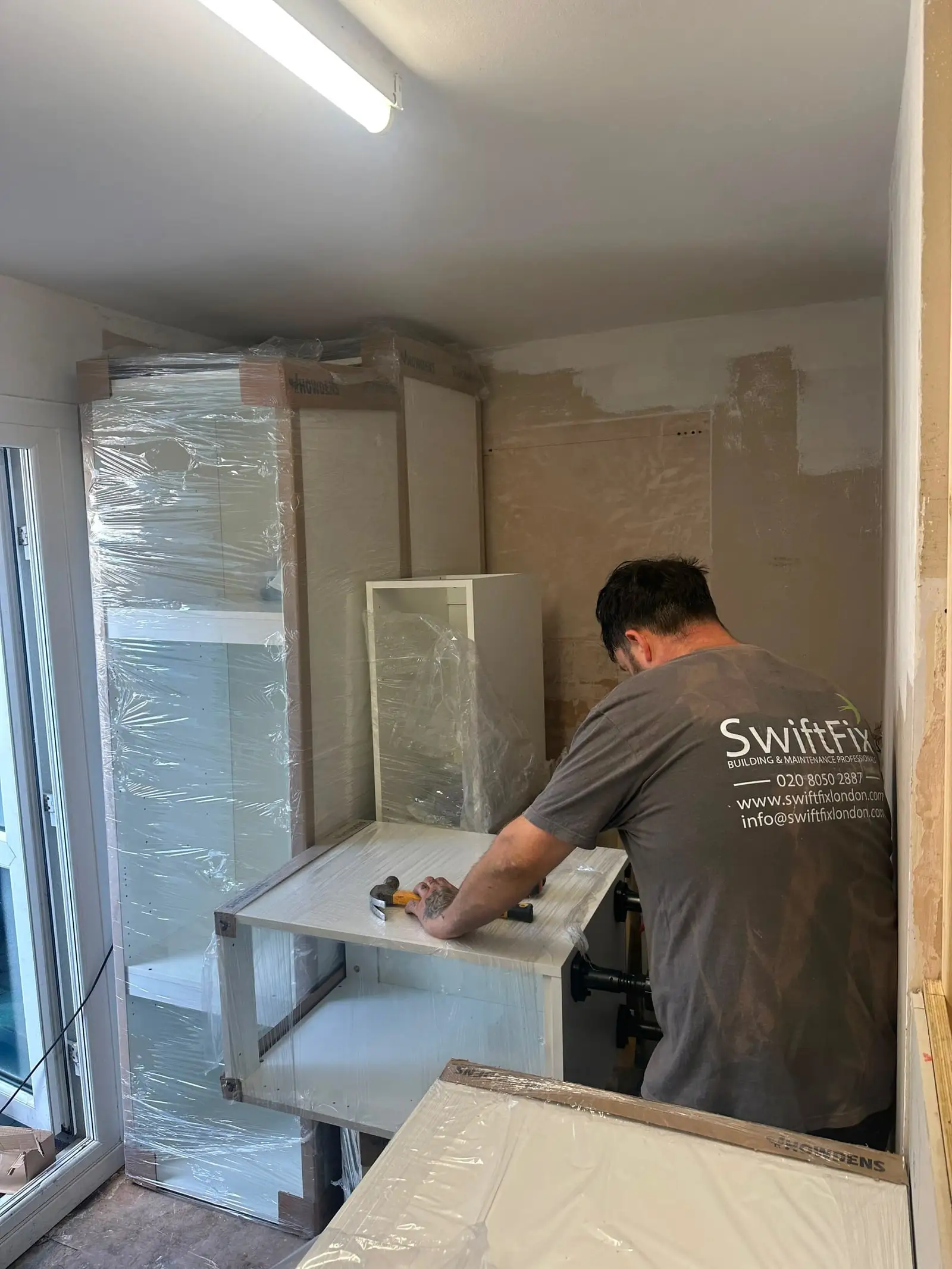 Kitchen units being fitted
