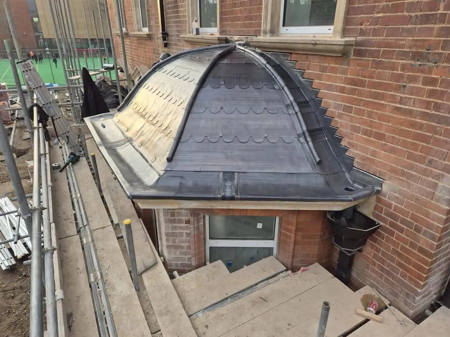 Hand-dressed lead cladding to a domed bay roof, seen from scaffolding