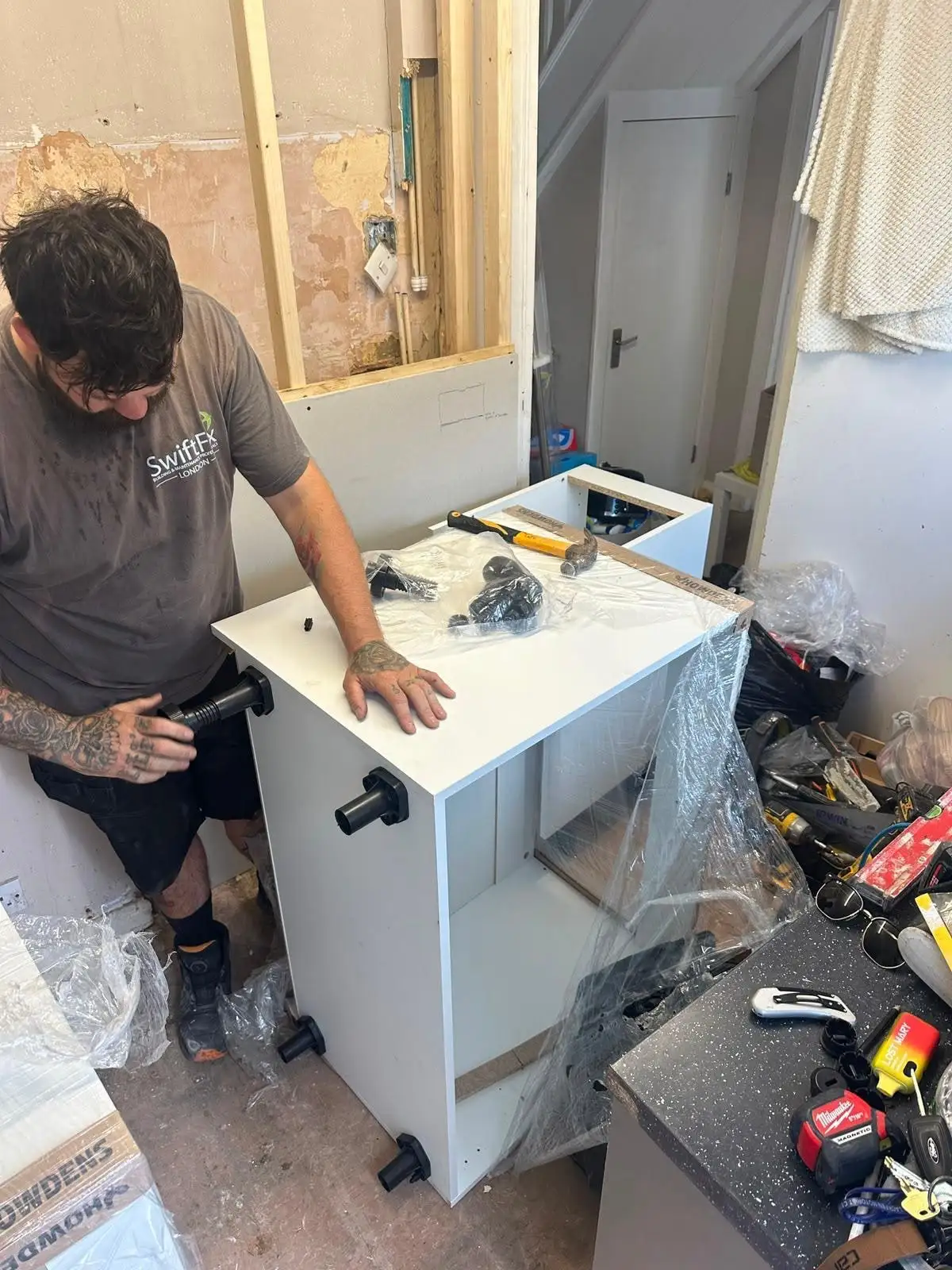 Swift Fix plumber fitting a new vanity unit during a bathroom installation