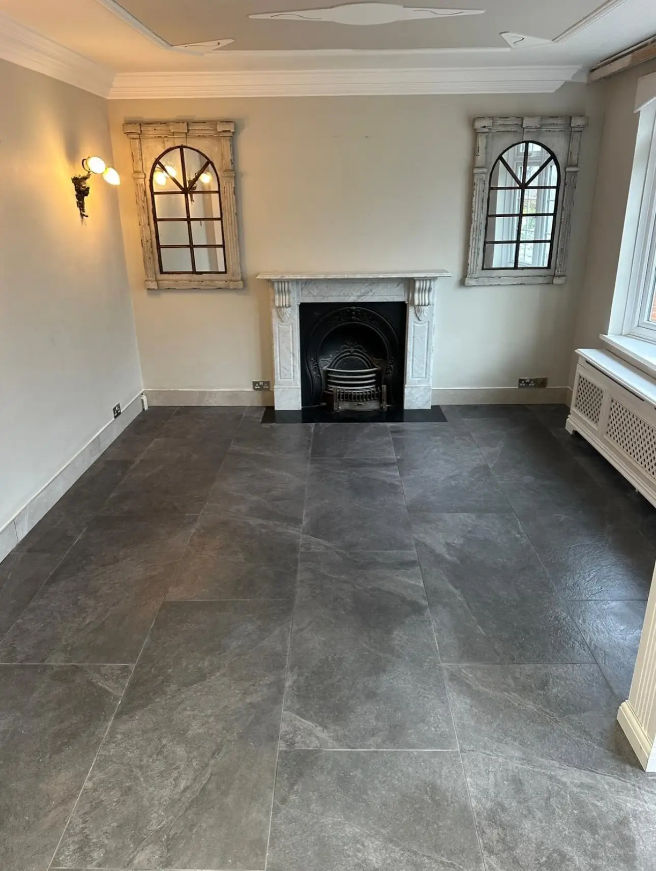 Refurbished reception room with fireplace and new tiled floor