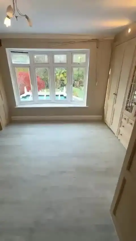 Ground-floor reception room with slate-effect floor tiles and fireplace