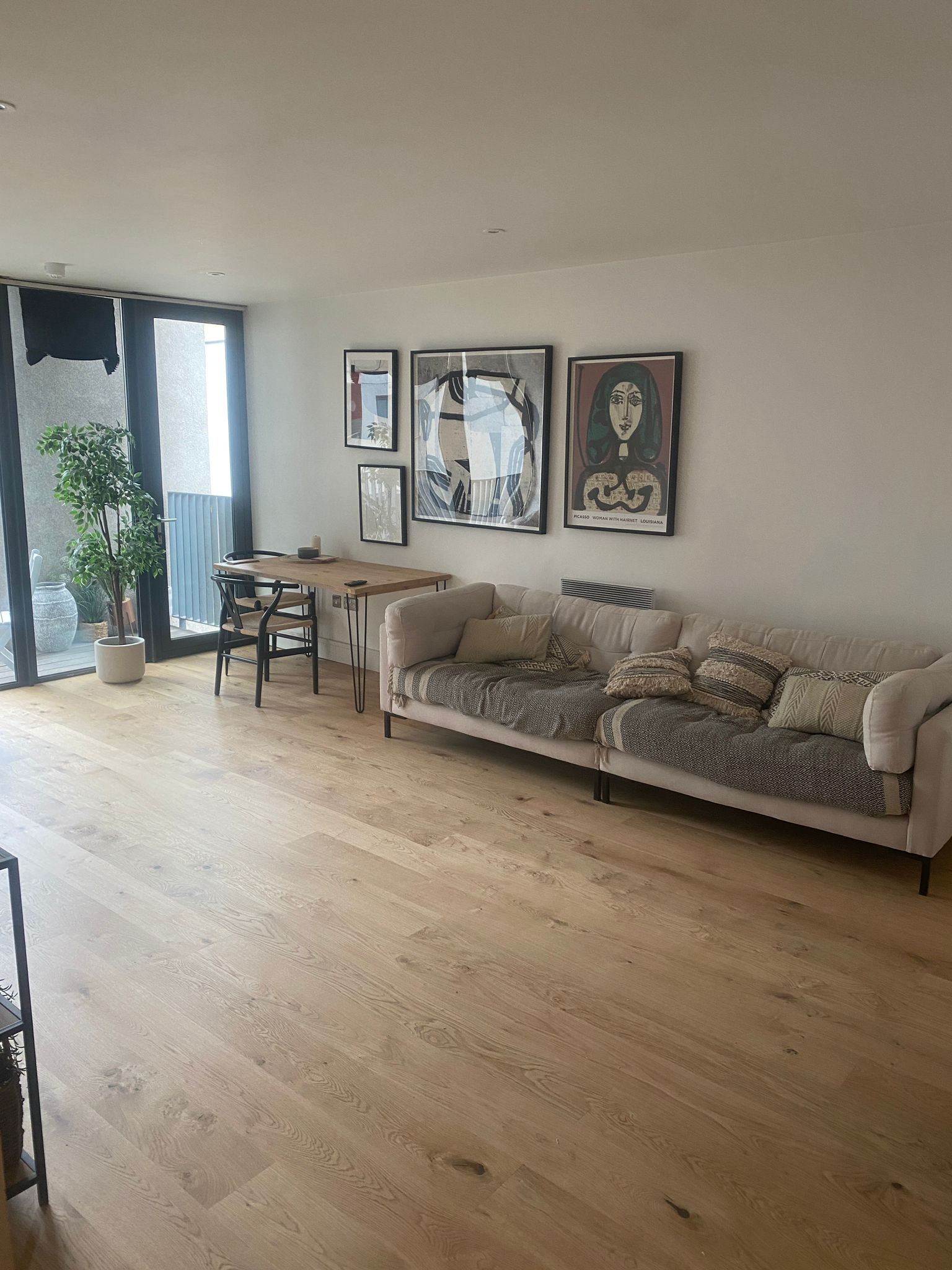 Building Services by swiftfix london - Renovated living room with wood flooring and modern decor by SwiftFix London